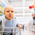 young-mother-with-her-little-baby-boy-at-the-supermarket-picture-id875222634