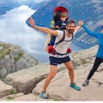 cheerful-couple-and-their-little-kid-in-the-summit-of-the-pulpit-rock-picture-id1091937476