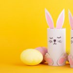 cute-easter-bunnies-made-of-paper-with-colorful-easter-eggs-picture-id1296827697