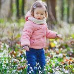 cute-toddler-girl-standing-in-the-grass-with-many-snowdrop-flowers-in-picture-id1208181249 (1)