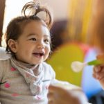 mother-feeding-her-baby-with-spoon-picture-id1189121934