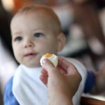 toddler-eating-boiled-egg-picture-id497869614