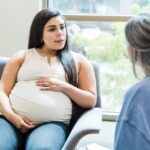 pregnant-woman-upset-with-unrecognizable-female-therapist-picture-id1426642888