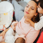A busy mom talks on the phone and baby