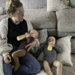 Mother feeding her baby twin